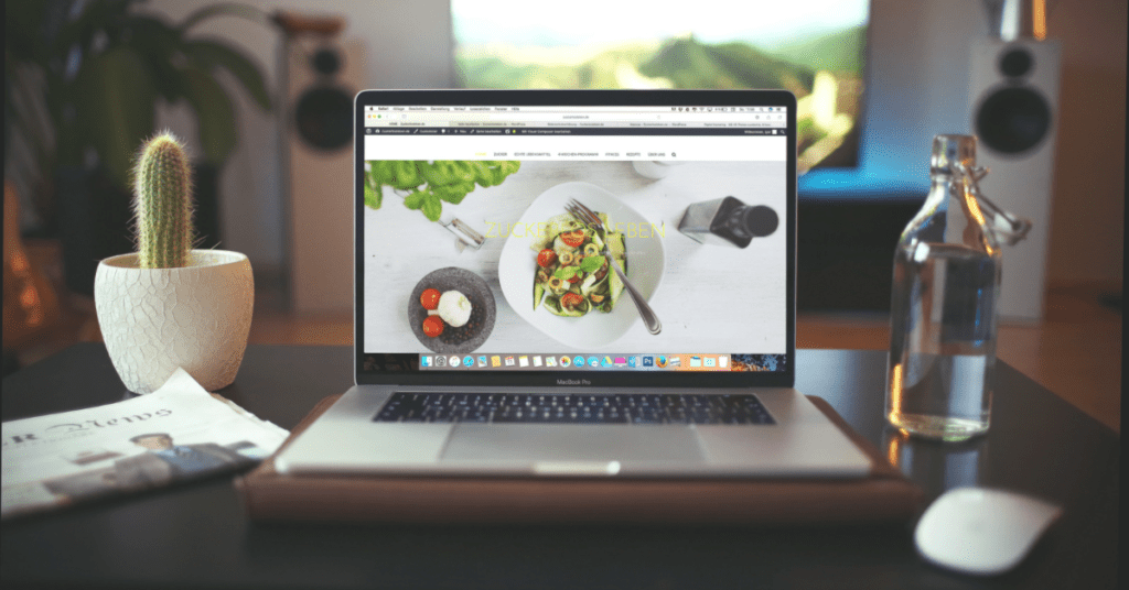 computer on desk with a food website displayed