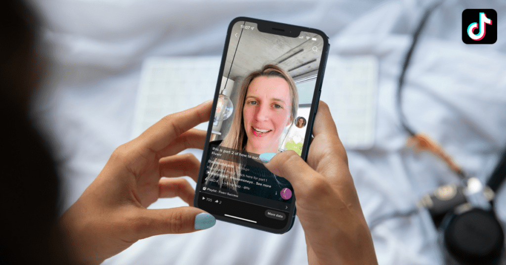 Hand holding phone looking at a TikTok video